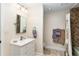 Bathroom with a single sink vanity, tiled shower/tub, and neutral color scheme at 7563 Nw 21St St, Ocala, FL 34482
