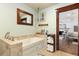 Bathroom with large tub, tile surround, and views into the connected main bedroom at 7563 Nw 21St St, Ocala, FL 34482