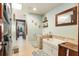 Hall bathroom with large tub, tile floors, and a stacked washer and dryer at 7563 Nw 21St St, Ocala, FL 34482