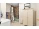 Bathroom featuring a tiled shower/tub, vanity, and a storage cabinet at 7563 Nw 21St St, Ocala, FL 34482