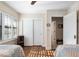 Bedroom featuring twin beds, closet, hardwood floors, and a sunlit window at 7563 Nw 21St St, Ocala, FL 34482