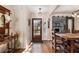 Inviting entryway with hardwood floors, charming decor, and open access to dining area at 7563 Nw 21St St, Ocala, FL 34482