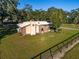 A charming ranch-style home boasts a brick facade, metal roof, and well-manicured lawn at 7563 Nw 21St St, Ocala, FL 34482