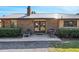 A brick home with a metal roof is complemented by a cozy patio, perfect for relaxing outdoors at 7563 Nw 21St St, Ocala, FL 34482