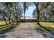 Picturesque home with a private driveway, lush landscaping, and mature trees at 7563 Nw 21St St, Ocala, FL 34482