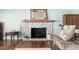 Living room featuring a stone fireplace with a wooden mantle and a decorative mirror at 7563 Nw 21St St, Ocala, FL 34482