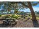 Enjoy the beautiful outdoor area with a picnic table, water feature, and mature trees at 7563 Nw 21St St, Ocala, FL 34482