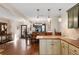 Bright kitchen featuring pendant lighting, hardwood flooring, and a partial view of the dining room at 7563 Nw 21St St, Ocala, FL 34482