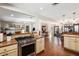 Well-lit kitchen featuring stainless steel appliances, cream colored cabinets, and an open floor plan at 7563 Nw 21St St, Ocala, FL 34482