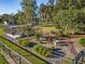 Well-maintained landscaping with mature trees, a gazebo, and decorative plants enhances the outdoor living space at 7563 Nw 21St St, Ocala, FL 34482