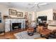 Bright living room features a stone fireplace, a ceiling fan, and hardwood floors at 7563 Nw 21St St, Ocala, FL 34482
