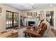 Bright living room featuring a stone fireplace, hardwood floors, and french doors to the outdoors at 7563 Nw 21St St, Ocala, FL 34482