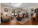 Spacious living room features a stone fireplace, ceiling fan, hardwood floors, and french doors to outside at 7563 Nw 21St St, Ocala, FL 34482