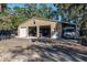 Exterior view of a large outbuilding with multiple garage doors and a concrete driveway at 7563 Nw 21St St, Ocala, FL 34482