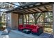 Relax in style with this outdoor screened-in lounge area with stylish seating and views of the grounds at 7563 Nw 21St St, Ocala, FL 34482