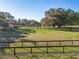 Large fenced-in pasture with plenty of room for horses to roam and graze under mature shade trees at 7563 Nw 21St St, Ocala, FL 34482