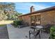 Charming brick home featuring an outdoor patio with lounge chairs and a serene view of the surrounding landscape at 7563 Nw 21St St, Ocala, FL 34482