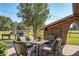 Inviting outdoor patio features comfortable seating, a grill, and string lights for a cozy ambiance at 7563 Nw 21St St, Ocala, FL 34482