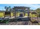 Outdoor wooden pergola featuring bar seating and a serene view of the surrounding acreage at 7563 Nw 21St St, Ocala, FL 34482