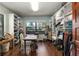 Large walk-in closet with custom shelving, drawers, a window and wood floors at 7563 Nw 21St St, Ocala, FL 34482