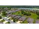 Lovely aerial view of a neighborhood with mature landscaping, manicured lawns, and a tranquil lake at 7814 Sw 97Th Cir, Ocala, FL 34481