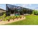 Lush backyard with screened pool, landscaped beds and inviting outdoor living space at 7814 Sw 97Th Cir, Ocala, FL 34481