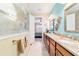 Bathroom view featuring double sinks, granite countertops, and access to an additional room at 7814 Sw 97Th Cir, Ocala, FL 34481