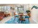 Dining room with a view of the screened-in lanai, seating for four, and neutral tile floors at 7814 Sw 97Th Cir, Ocala, FL 34481