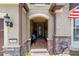 Inviting front porch with stone accents, seating, and views of the well-kept lawn at 7814 Sw 97Th Cir, Ocala, FL 34481