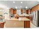 Spacious kitchen with stainless appliances, granite countertops, wood cabinets, and island with seating at 7814 Sw 97Th Cir, Ocala, FL 34481