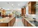 Large kitchen with granite countertops, stainless appliances, island seating and view to living room at 7814 Sw 97Th Cir, Ocala, FL 34481