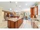 Spacious open concept kitchen with center island, stainless appliances, wood cabinets, and tile floors at 7814 Sw 97Th Cir, Ocala, FL 34481