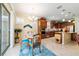 Bright eat-in kitchen featuring stainless appliances, a granite island, wood cabinets, and a breakfast nook at 7814 Sw 97Th Cir, Ocala, FL 34481