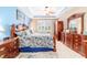 Primary bedroom features a tray ceiling, ceiling fan, and plantation shutters on the windows at 7814 Sw 97Th Cir, Ocala, FL 34481