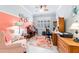 Inviting office space with a unique coral accent wall, plantation shutters, and ample natural light at 7814 Sw 97Th Cir, Ocala, FL 34481