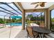Screened patio with a view of the pool and lush landscaping provides an inviting retreat at 7814 Sw 97Th Cir, Ocala, FL 34481