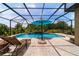 Relaxing screened pool area with chaise lounge, outdoor umbrella and lovely water feature at 7814 Sw 97Th Cir, Ocala, FL 34481