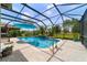 Screened pool with waterfall feature, lush landscaping, and a relaxing outdoor space at 7814 Sw 97Th Cir, Ocala, FL 34481