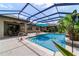 Inviting screened pool with waterfall feature and patio area, perfect for outdoor entertaining at 7814 Sw 97Th Cir, Ocala, FL 34481
