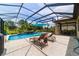 Screened pool with waterfall, with lounge chairs and outdoor seating offering relaxation at 7814 Sw 97Th Cir, Ocala, FL 34481