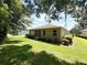 Spacious backyard featuring lush greenery, a screened-in lanai, and privacy landscaping at 8303 Sw 78Th Cir, Ocala, FL 34476