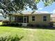 View of home's backyard, featuring a well-maintained lawn and a screened-in lanai at 8303 Sw 78Th Cir, Ocala, FL 34476