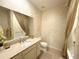 Bathroom features an ornate mirror, vanity, tile flooring, decorative flowers, and a shower at 8303 Sw 78Th Cir, Ocala, FL 34476