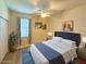 Bedroom includes a comfortable bed, ceiling fan, and natural light coming through a large window at 8303 Sw 78Th Cir, Ocala, FL 34476