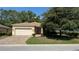 Charming single-story home featuring a brick driveway, attached garage, and well-manicured landscaping at 8303 Sw 78Th Cir, Ocala, FL 34476
