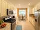 Well-equipped kitchen with stainless steel appliances and a breakfast table at 8303 Sw 78Th Cir, Ocala, FL 34476