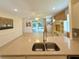 Open concept kitchen with stainless steel sink, tile flooring, and view to the great room at 8303 Sw 78Th Cir, Ocala, FL 34476