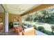 Outdoor lanai has comfortable seating, ceiling fan, and a great view of the manicured backyard at 8303 Sw 78Th Cir, Ocala, FL 34476