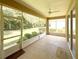 Screened in lanai with a view of the backyard, ceiling fan, and new outdoor carpeting at 8303 Sw 78Th Cir, Ocala, FL 34476