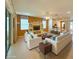Comfortable living area with tile floors, a ceiling fan, and open access to kitchen with barstool seating at 8303 Sw 78Th Cir, Ocala, FL 34476